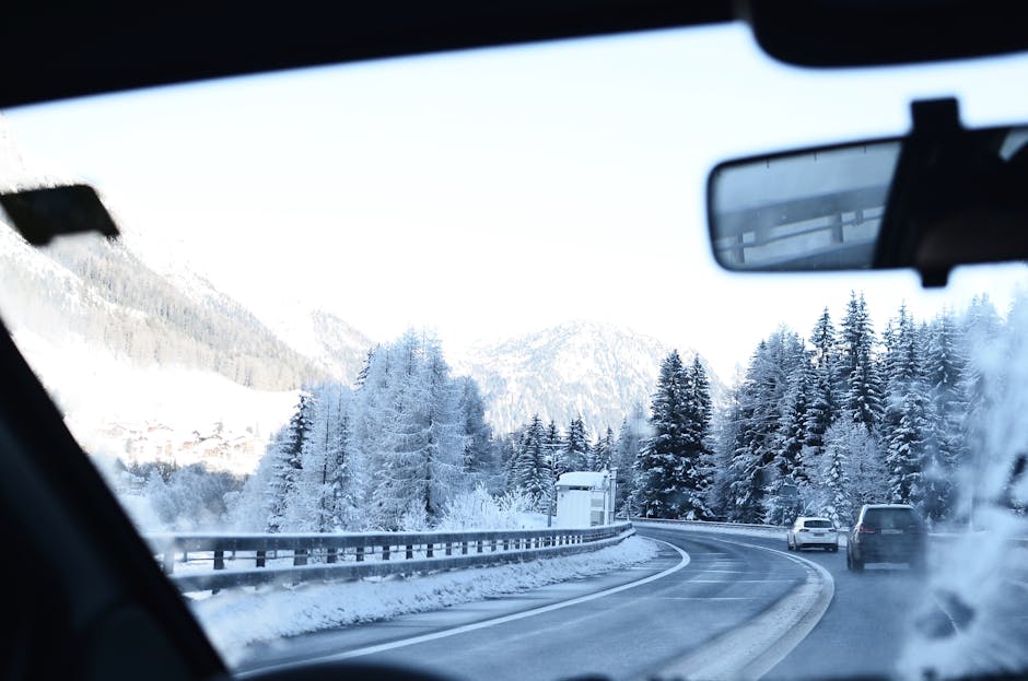 Scenic winter view of a snowy road through the Swiss Alps, perfect for winter travel themes.